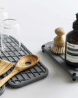 slate dish pad with utensils and glassware and slate sink caddy with scrubber and soap