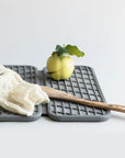slate dish pad with spoon and fruits
