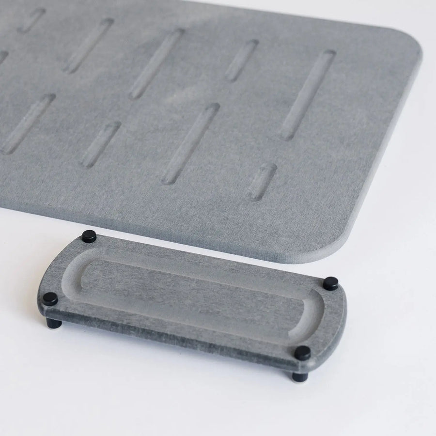dark grey shower bath mat with elegant modern sink caddy with black metal feet