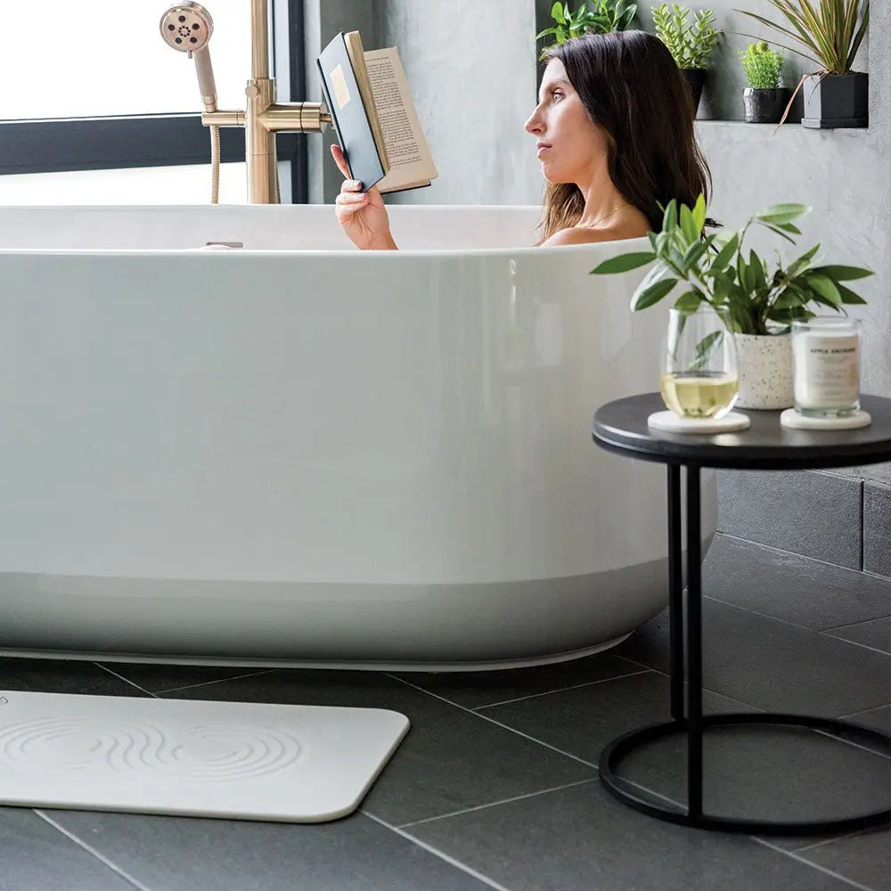 Sandstone Bath Stone™ with woman reading in tub