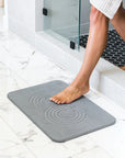 Woman stepping onto Slate Bath Stone™
