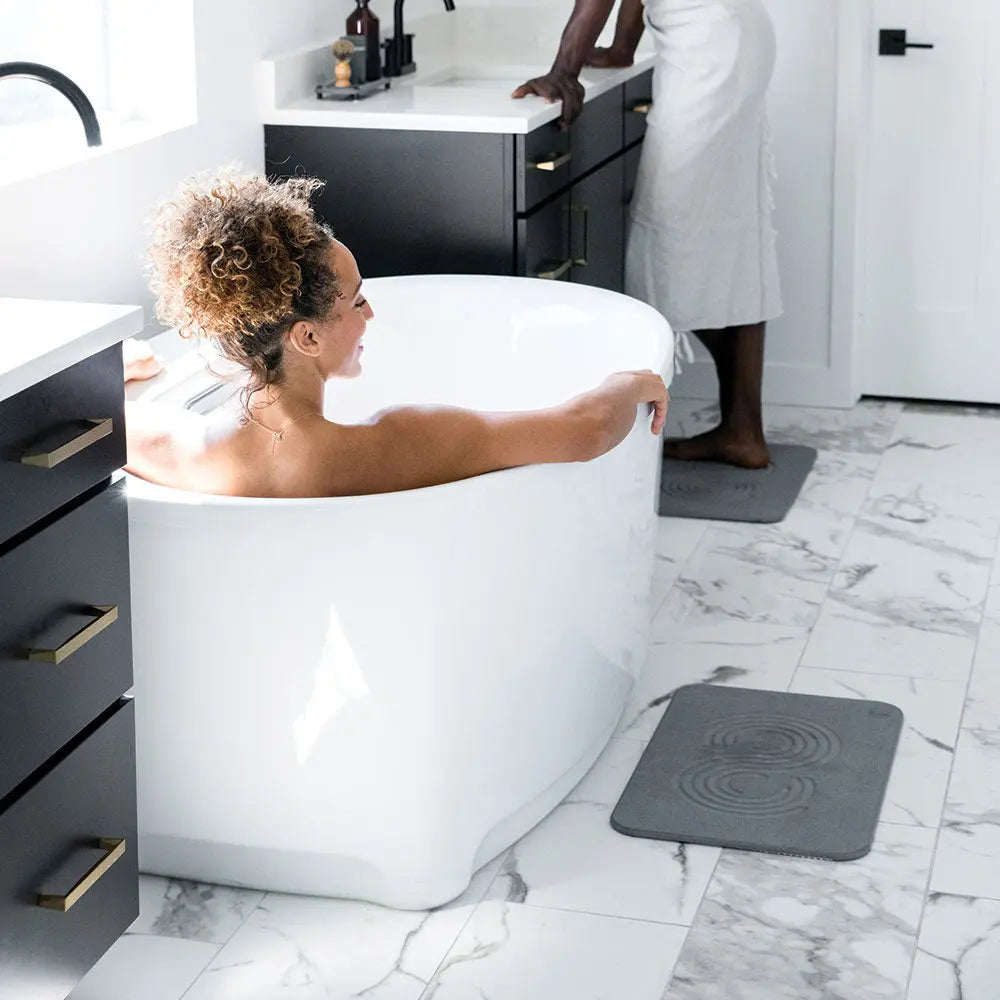 Man and woman in bathroom with Slate Bath Stones™